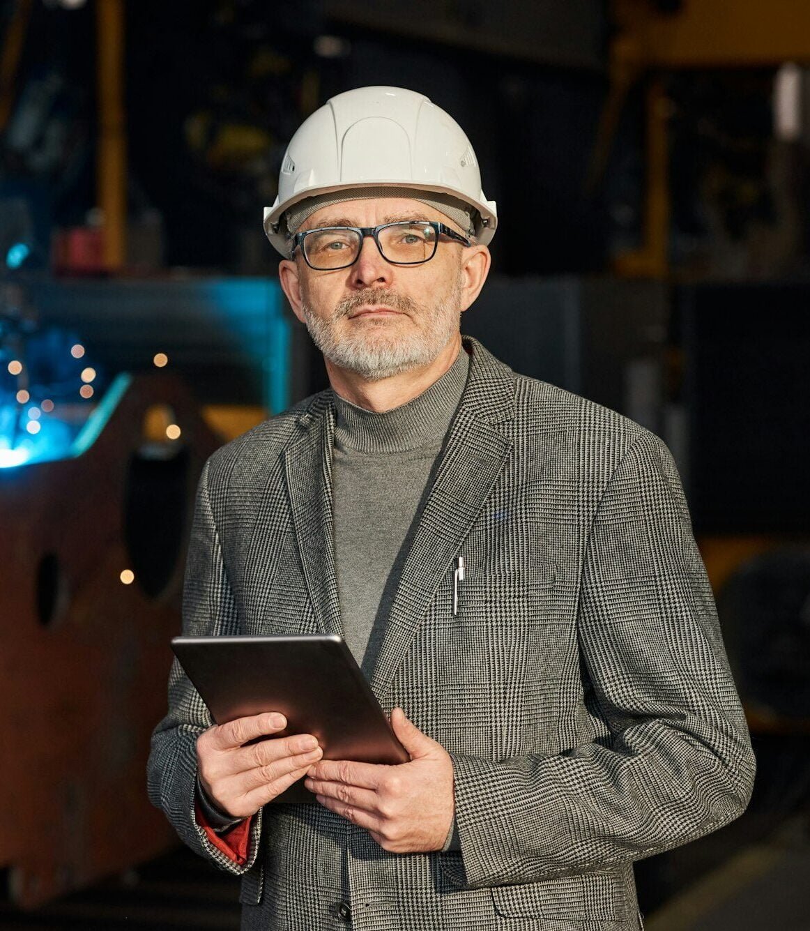 Foreman with tablet pc working at factory